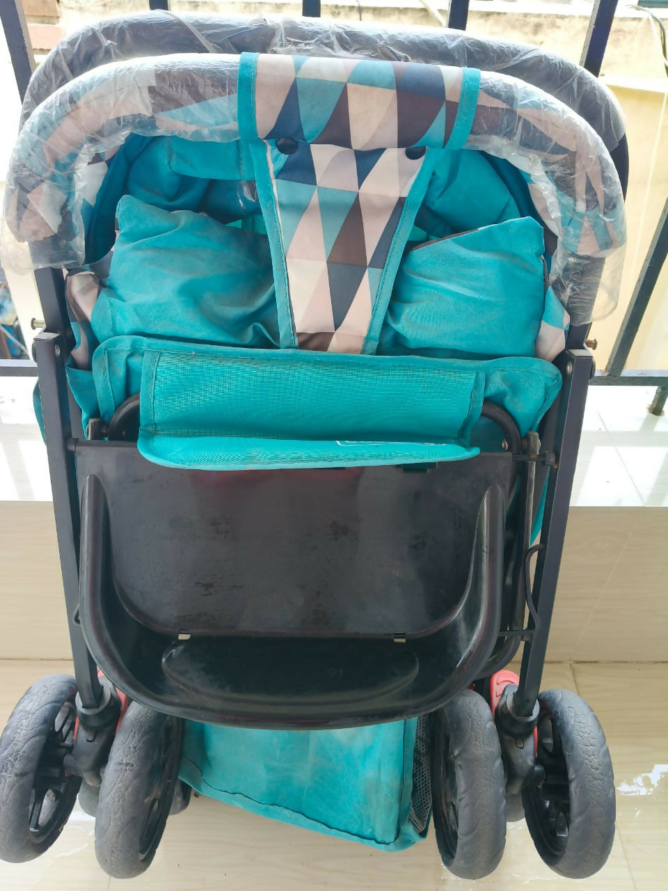 BABYHUG Cocoon Blue stroller with reclining seat, smooth wheels, safety harness, adjustable canopy, and comfortable travel design for babies and toddlers.