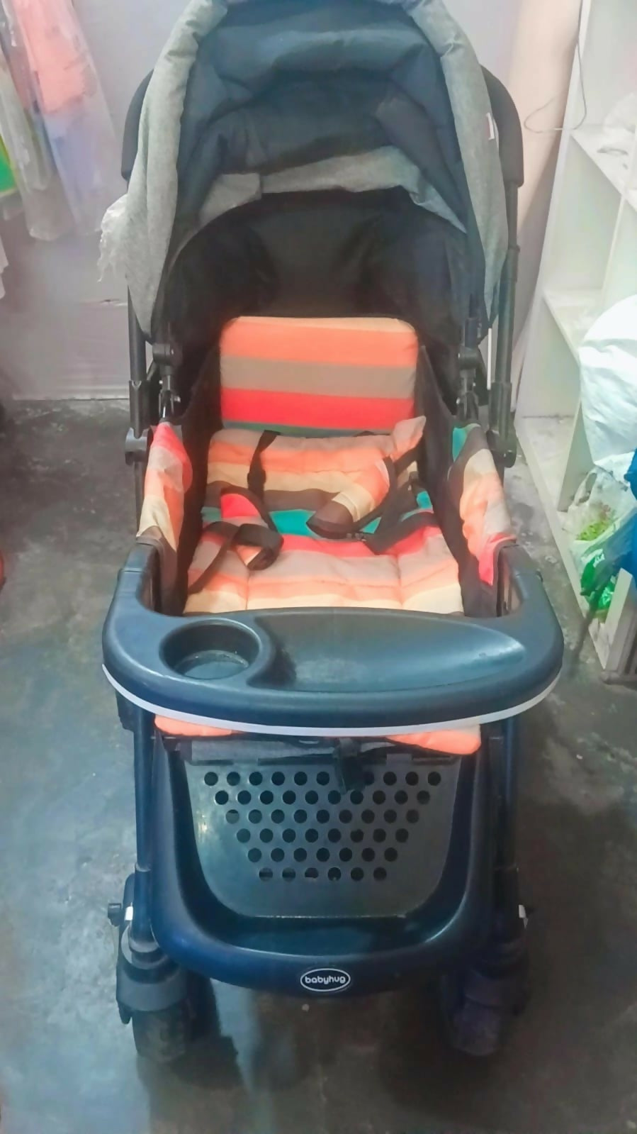 Babyhug Melody stroller with a reversible handle, adjustable canopy, reclining seat, 5-point safety harness, smooth wheels, and a lightweight foldable design for comfortable everyday travel.