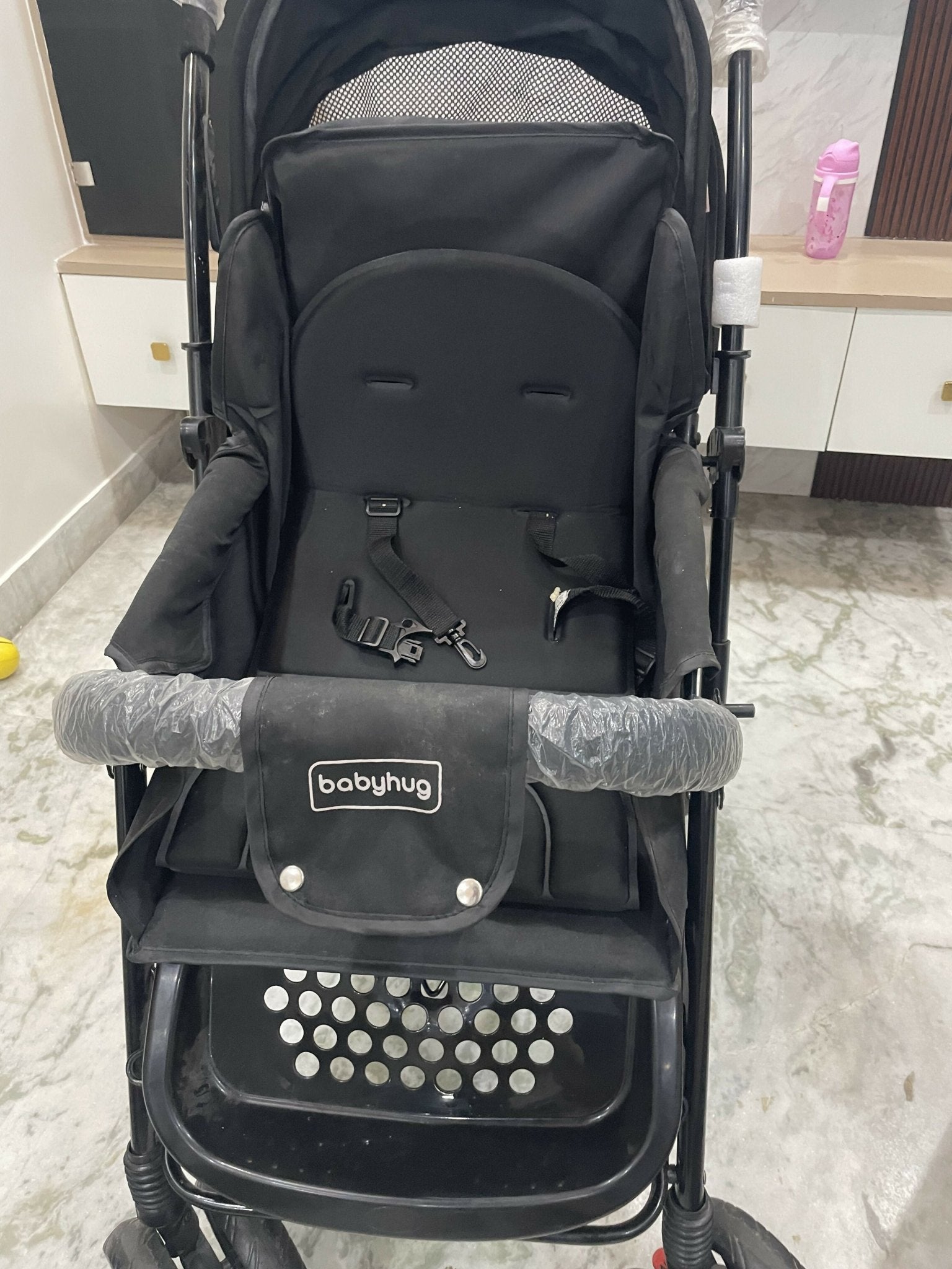 Evenflo travel system with baby stroller and infant car seat, featuring a foldable design, reclining seat, adjustable canopy, 5-point safety harness, and spacious storage basket for convenient travel.