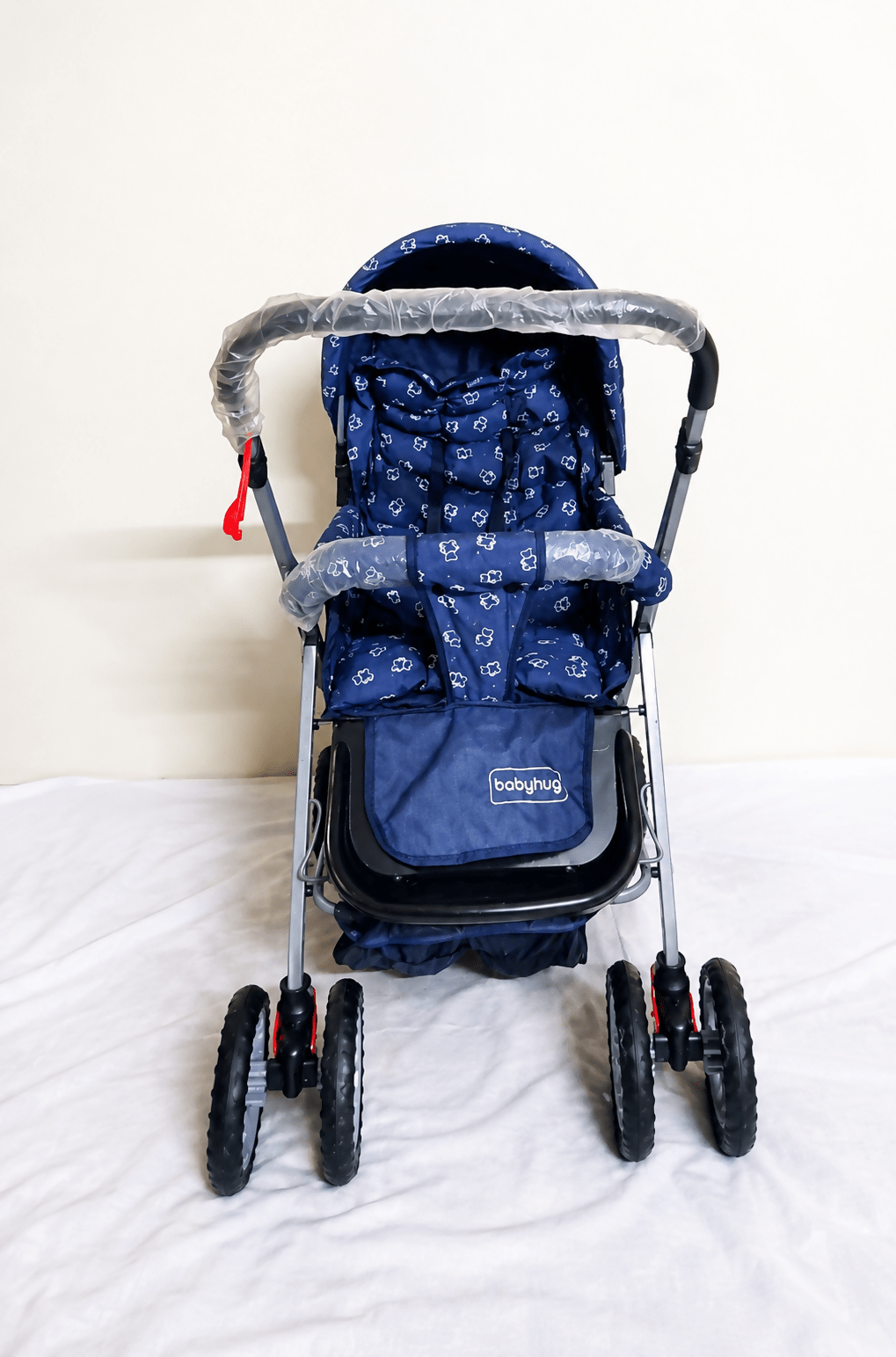 Babyhug Reversible Handle Baby Stroller Pram with mosquito net, reversible handle, reclining seat, foldable frame, 5-point safety harness, adjustable canopy, and storage basket for comfortable travel.