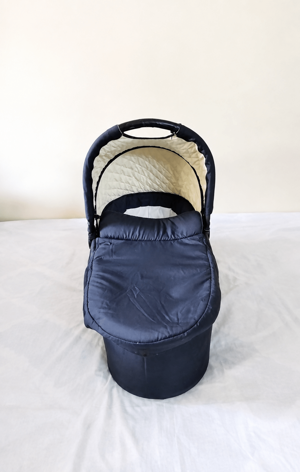 babycab Noah Carrycot Bassinet in Navy Blue, designed as a stroller attachment with a comfortable padded interior, protective canopy, sturdy construction, and cozy lie-flat space for newborns and young infants.