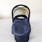 babycab Noah Carrycot Bassinet in Navy Blue, designed as a stroller attachment with a comfortable padded interior, protective canopy, sturdy construction, and cozy lie-flat space for newborns and young infants.