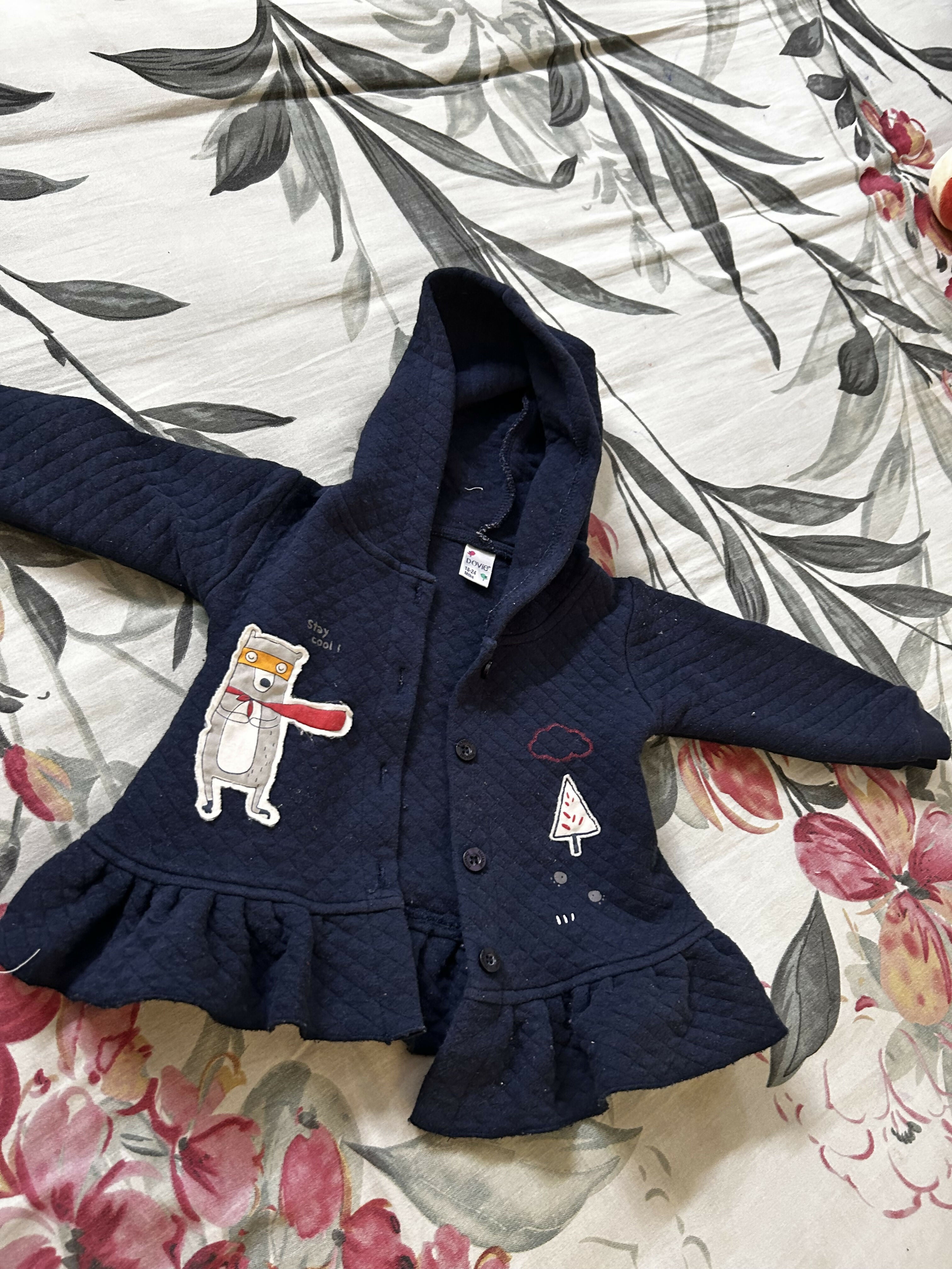 Blue baby sweater with soft knitted fabric, cozy warmth, comfortable fit, and classic design for everyday wear during cooler weather.