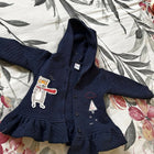 Blue baby sweater with soft knitted fabric, cozy warmth, comfortable fit, and classic design for everyday wear during cooler weather.
