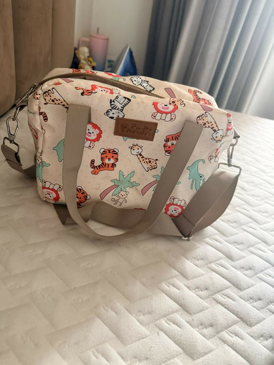 Diaper bag with multiple storage compartments, insulated bottle pockets, comfortable shoulder straps, and a spacious design for organizing baby essentials during travel and everyday outings.