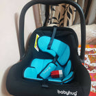 BABYHUG Amber Car Seat Cum Rocker in Almost New condition, featuring comfortable padded seating, safety harness, ergonomic carry handle, protective canopy, and versatile rocking function for convenient infant travel and supervised relaxation.