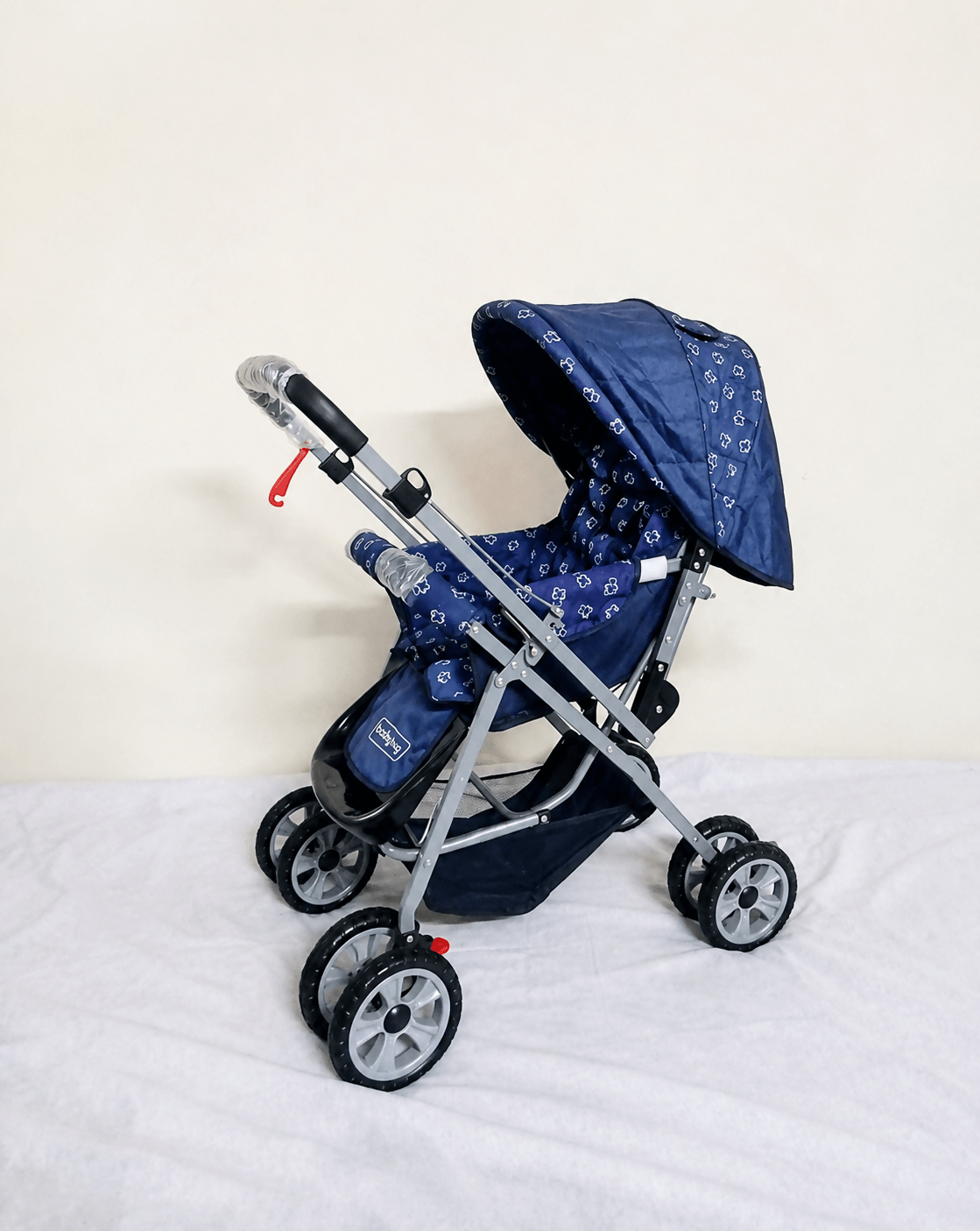 Babyhug Reversible Handle Baby Stroller Pram with mosquito net, reversible handle, reclining seat, foldable frame, 5-point safety harness, adjustable canopy, and storage basket for comfortable travel.