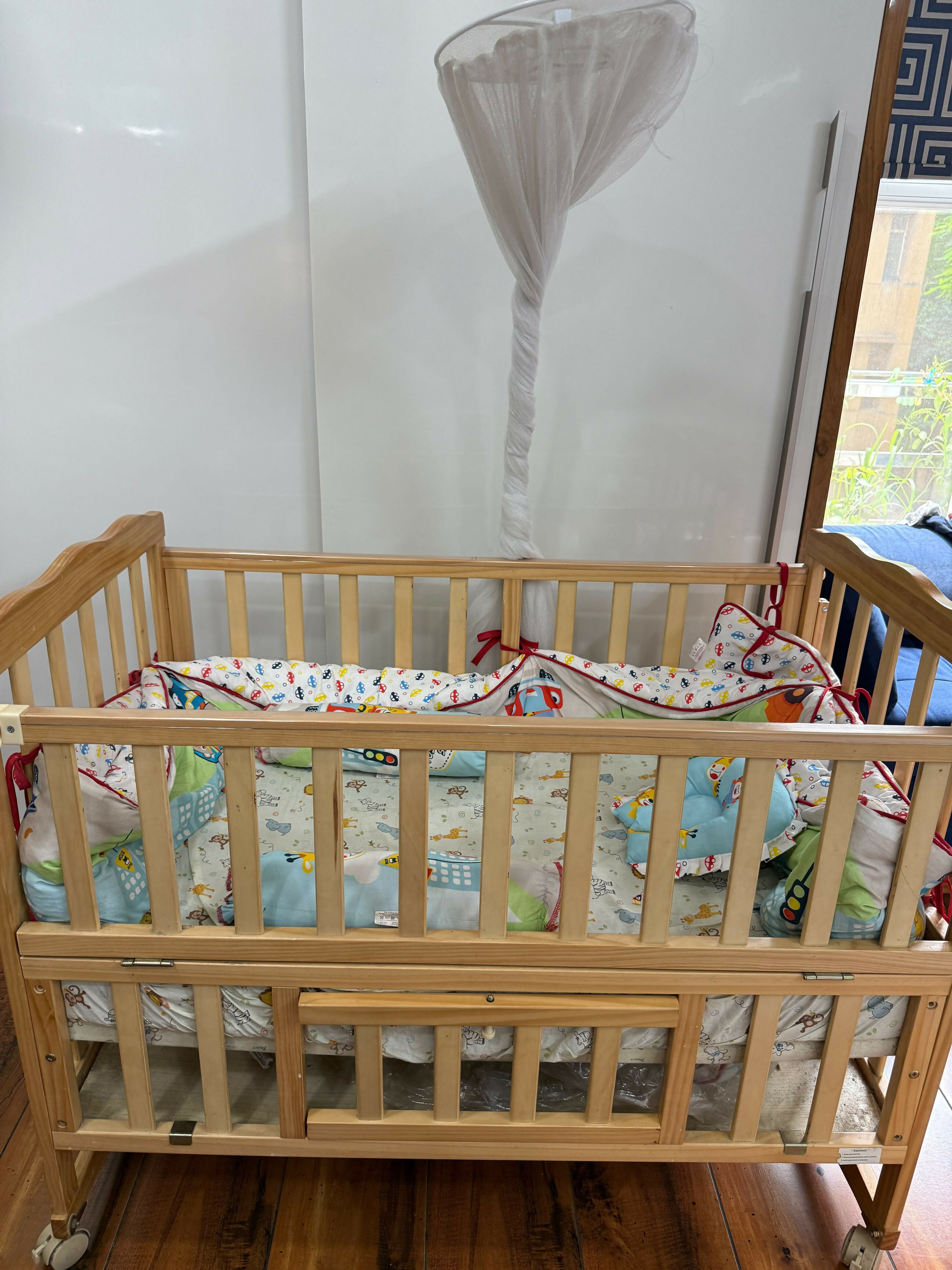BABYHUG Baby Cot Cum Rocker with Mattress in Some Used condition featuring a versatile cot and rocking design, comfortable mattress, sturdy frame, and protective side rails for baby's everyday rest and relaxation.