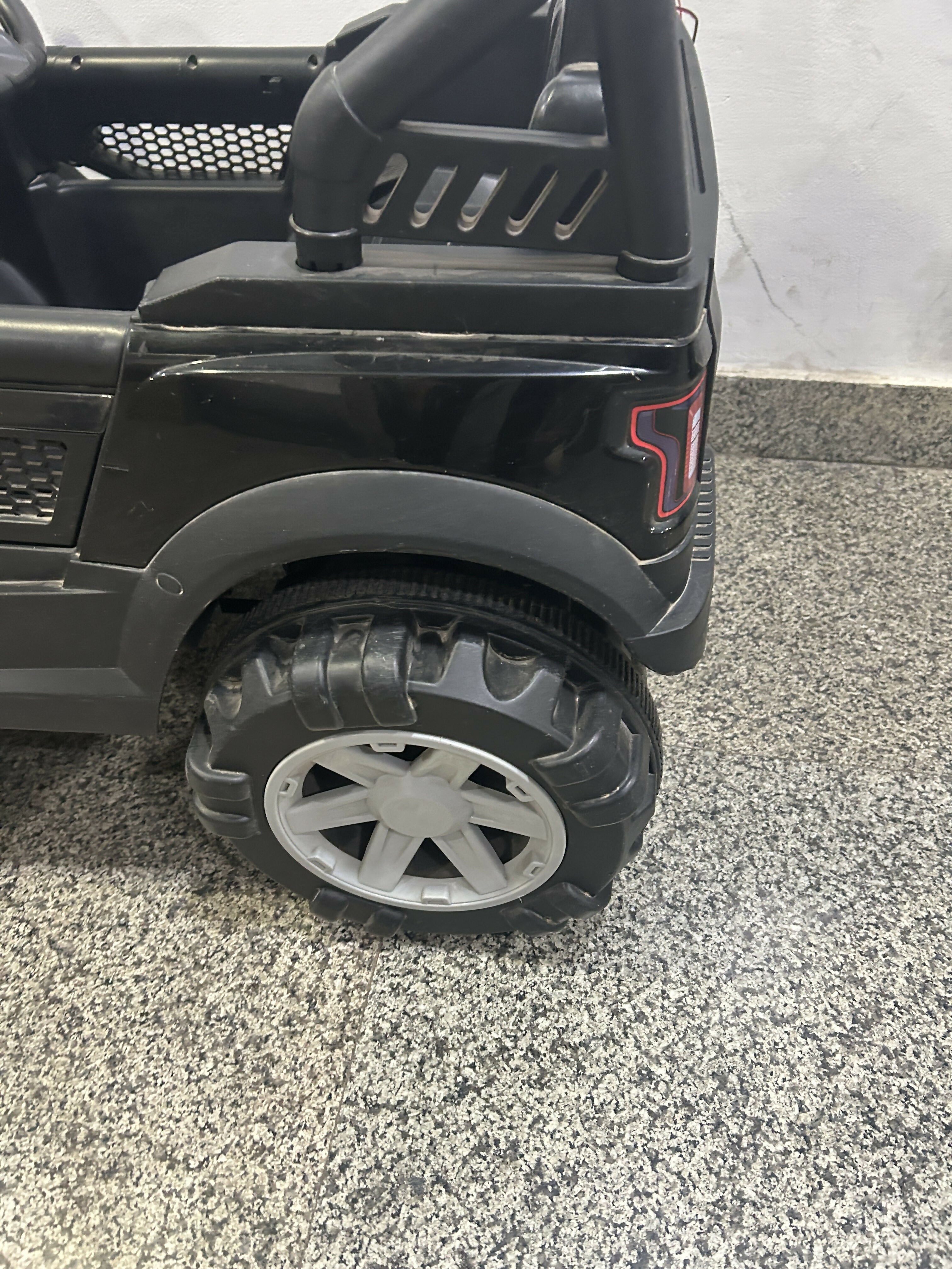 Battery Powered Ride-On Jeep for Toddlers in Some Used condition featuring a fun jeep-style design, comfortable seat, steering wheel, and rechargeable battery-powered operation for supervised indoor and outdoor play.