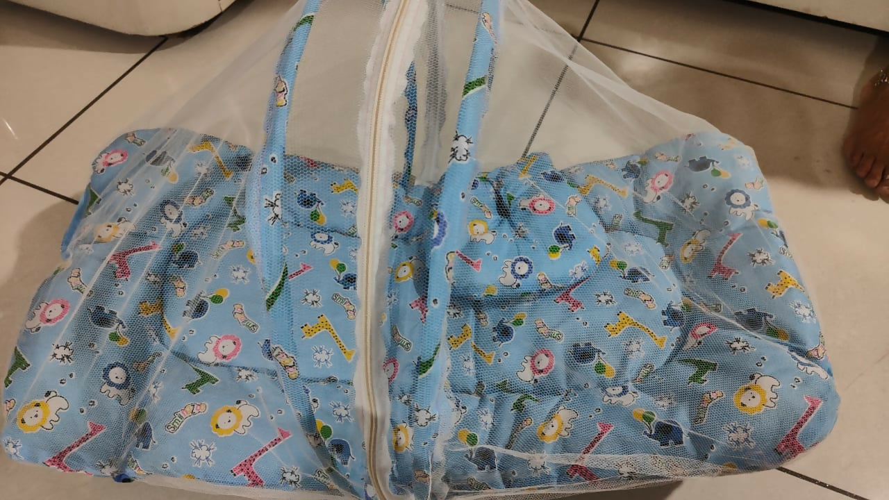 Bedding with mosquito net for newborn baby featuring a soft cushioned sleeping surface, protective mosquito net, cozy design, and comfortable support for restful sleep.