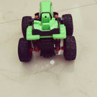 Toy car with green body and black wheels on a tiled floor