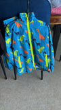 Blue windcheater jacket with multicolored dinosaur print, lightweight fabric, full-zip design, comfortable fit, and stylish protection for outdoor adventures and everyday wear.