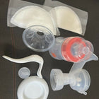 Collection of silicone breast pump parts on a dark surface