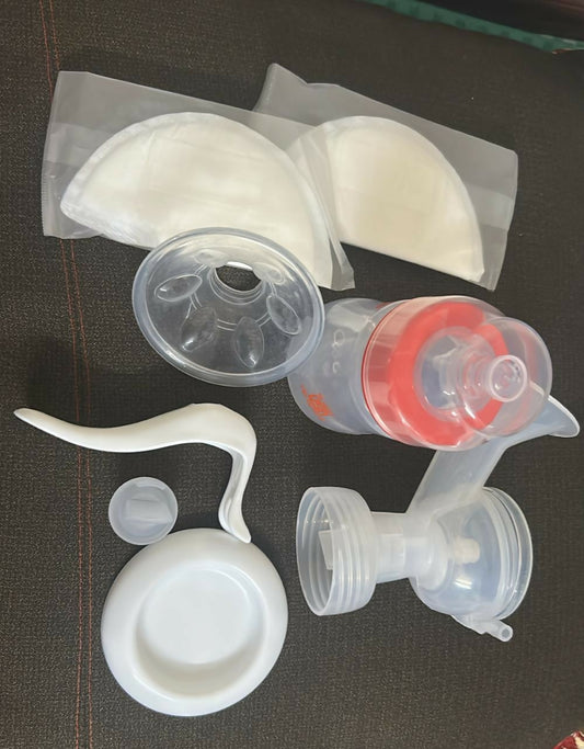 Collection of silicone breast pump parts on a dark surface