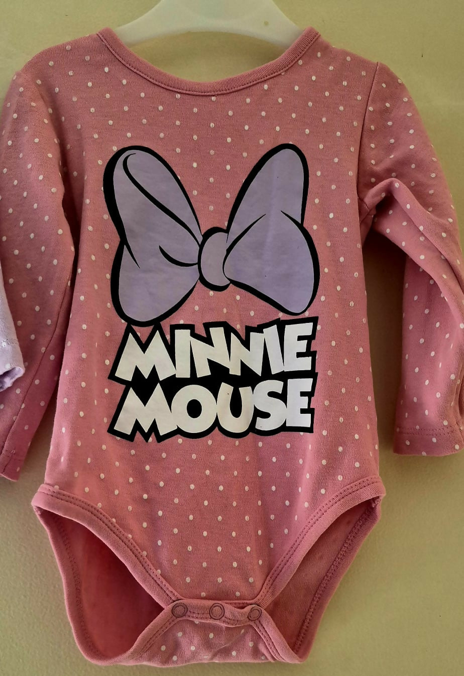 Pink 'Minnie Mouse' onesie with a purple bow 
