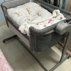 Chicco Next2Me Magic Eco co-sleeping crib with adjustable height, breathable mesh sides, drop-down side panel, lockable wheels, and a comfortable mattress for safe bedside sleeping.
