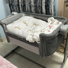 Chicco Next2Me Magic Eco co-sleeping crib with adjustable height, breathable mesh sides, drop-down side panel, lockable wheels, and a comfortable mattress for safe bedside sleeping.