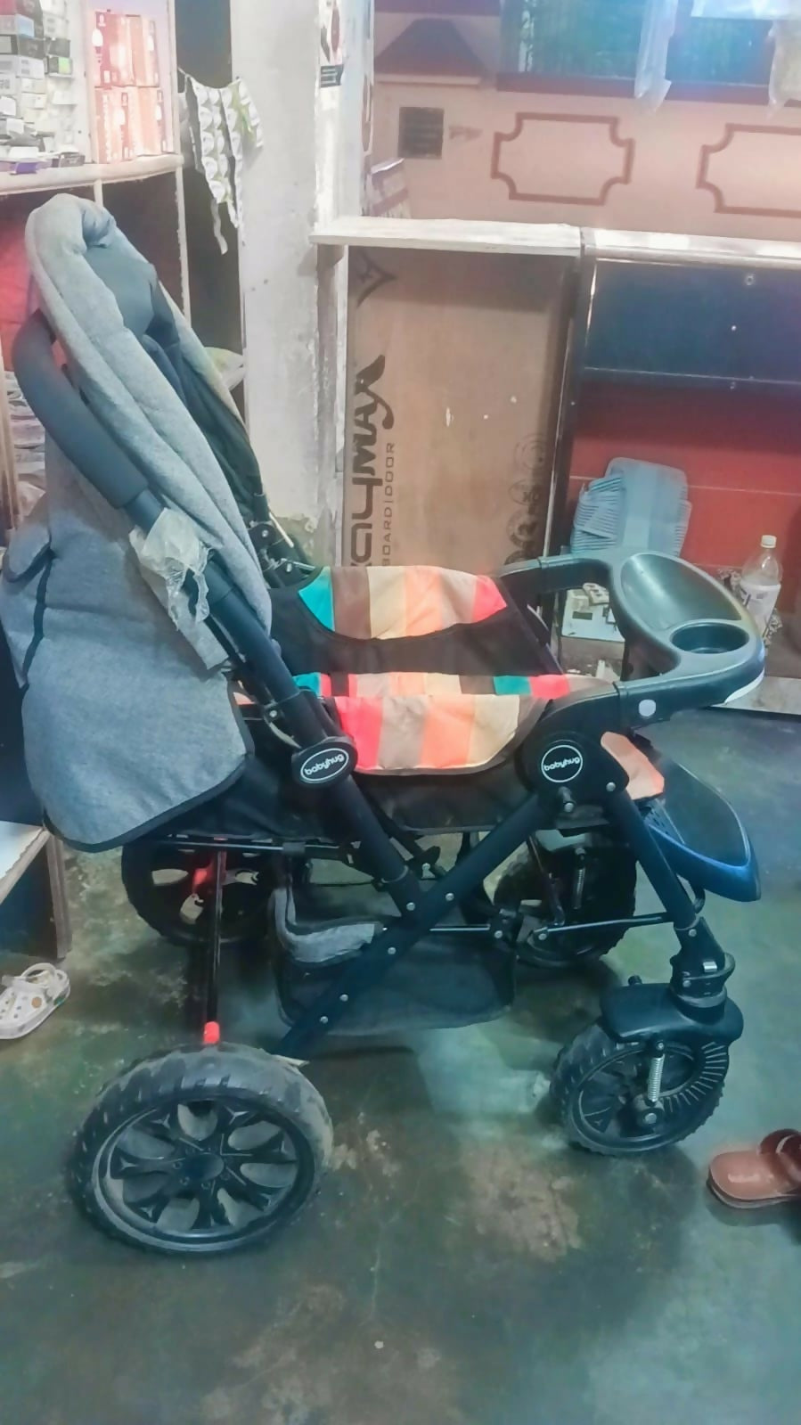 Babyhug Melody stroller with a reversible handle, adjustable canopy, reclining seat, 5-point safety harness, smooth wheels, and a lightweight foldable design for comfortable everyday travel.
