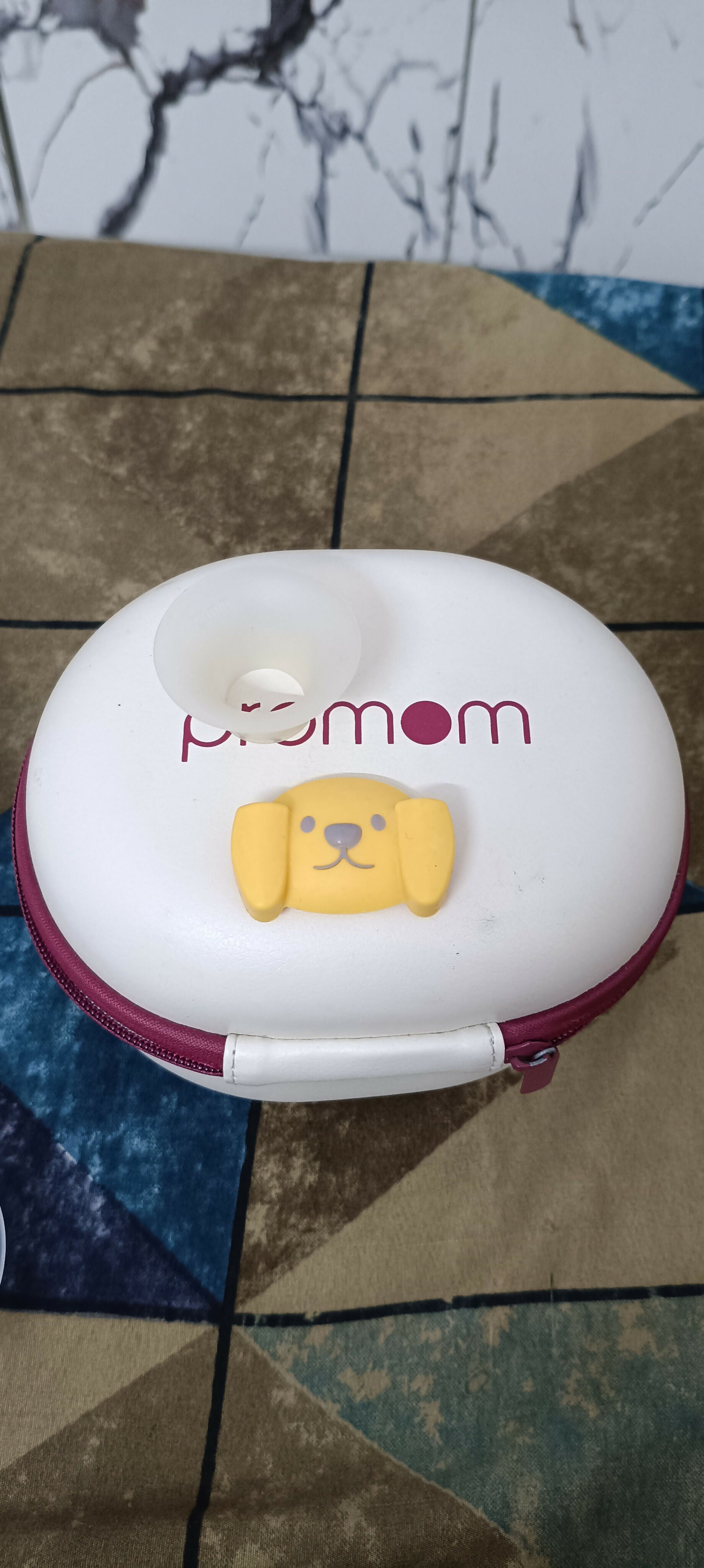 PROMOM electric wearable breast pump with hard case, hands-free design, compact milk collection cups, adjustable suction, and portable pumping support for breastfeeding mothers.