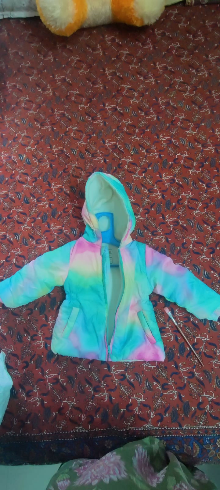 Cozy pastel tie-dye puffer jacket for kids featuring warm padded insulation, a soft lightweight design, front zip closure, and a trendy multicolor pattern for comfortable winter wear.