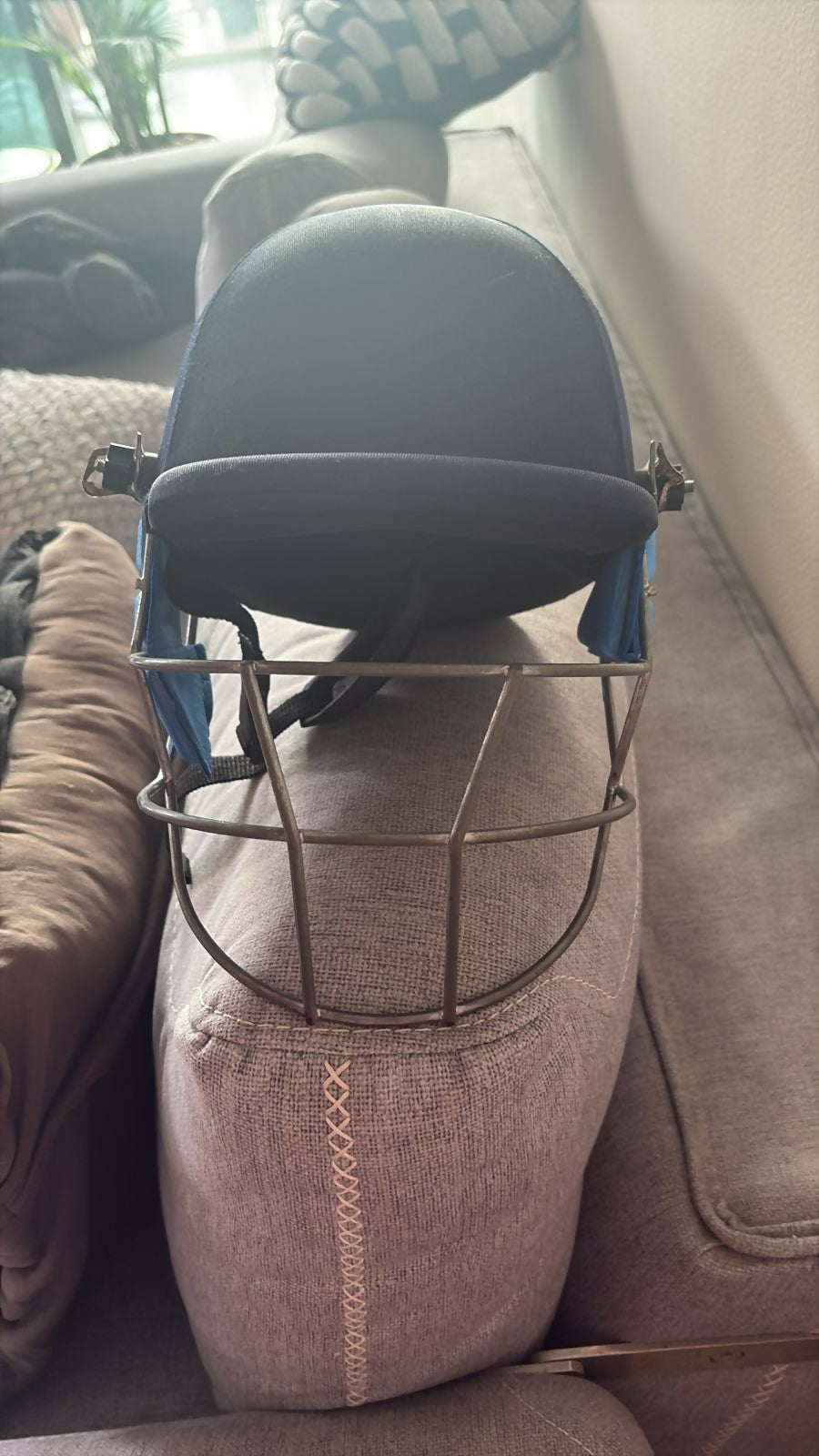 Cricket safety helmet and cricket cap designed for young players with protective construction, comfortable fit, adjustable support, and sporty styling for practice sessions and matches.