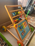 Children's wooden activity center with colorful toys 