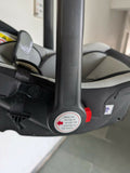 Close-up of a car seat with a label on the harness system.