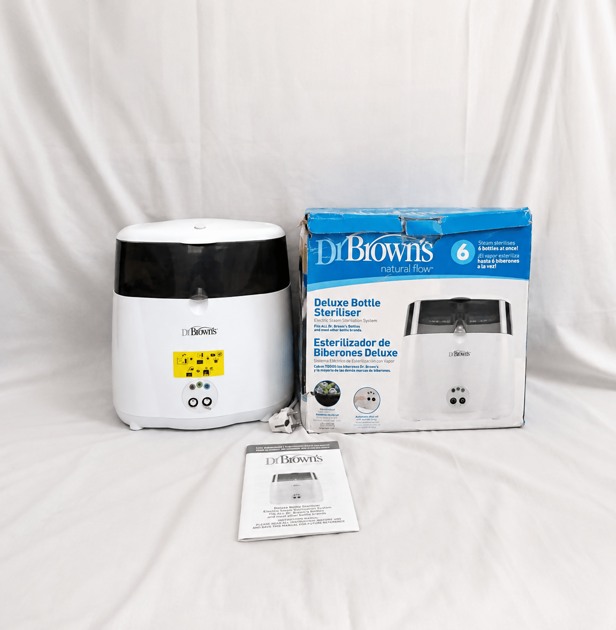 Dr. Brown's Deluxe electric steam bottle sterilizer with BPA-free construction, 6-bottle capacity, and spacious compartments for bottles, nipples, pacifiers, and baby feeding accessories.