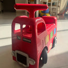 ELC Happyland Ride-On Bus with a colorful bus-inspired design, comfortable seat, sturdy wheels, easy-grip steering handle, and durable construction for fun indoor and outdoor riding play.