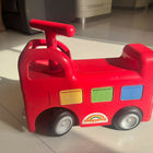 ELC Happyland Ride-On Bus with a colorful bus-inspired design, comfortable seat, sturdy wheels, easy-grip steering handle, and durable construction for fun indoor and outdoor riding play.