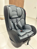 Gray and black car seat on a light wooden floor
