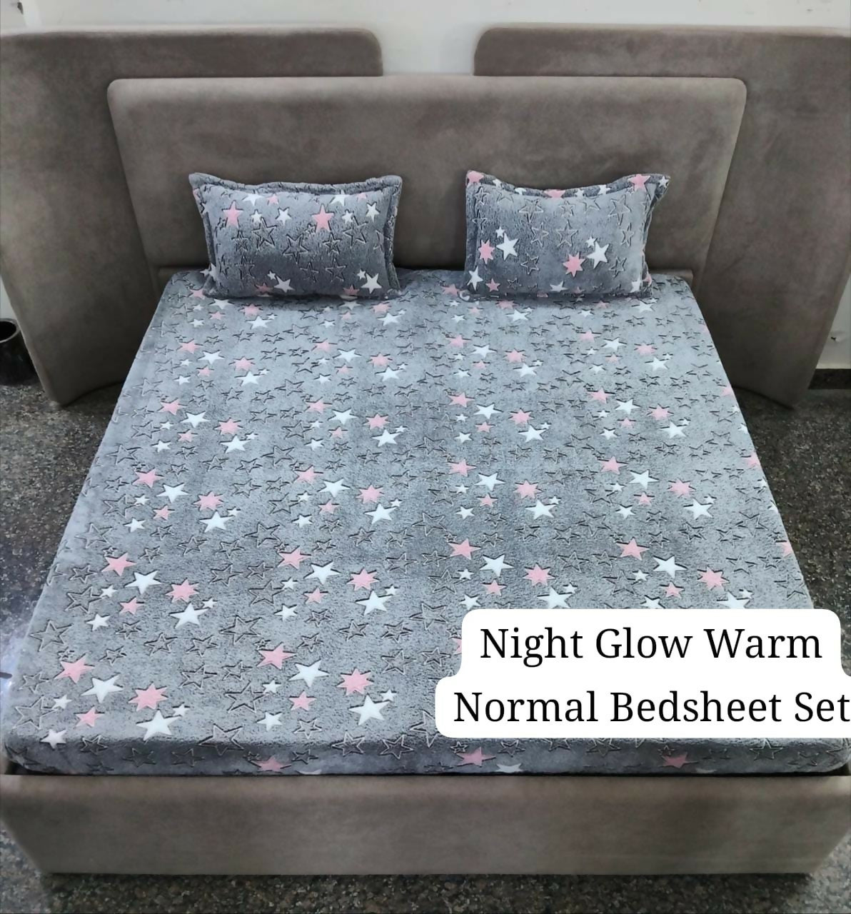 Gray star-patterned bedsheet set on a bed with pillows