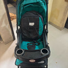 Green and black stroller with cup holders on a tiled floor.