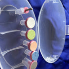 Clear nail drill with colored attachments on a blue background