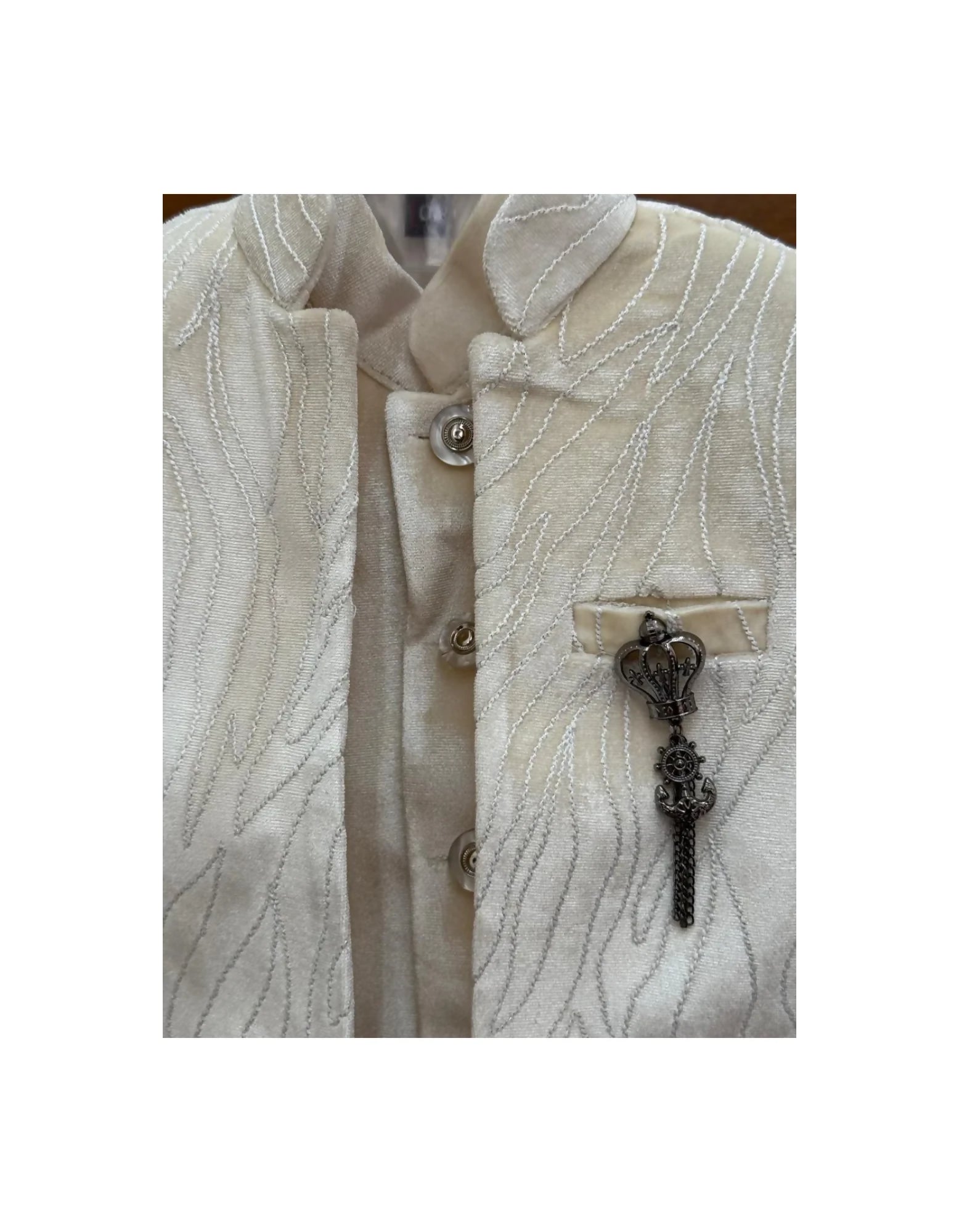 Close-up of a textured beige jacket with decorative buttons