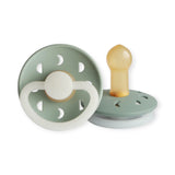 Two green baby pacifiers with wooden and silicone parts on a white background