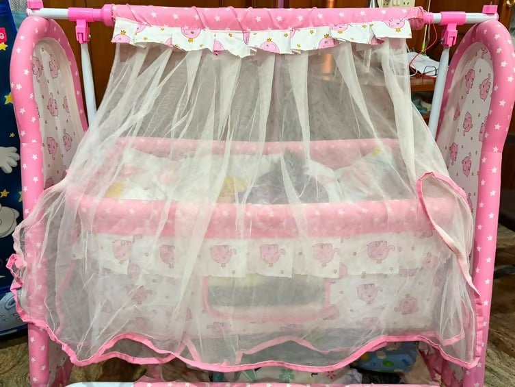 Fab N Funky Manual Cradle with a sturdy frame, gentle manual rocking motion, comfortable sleeping area, breathable design, and secure construction to provide a cozy resting space for newborns and infants.