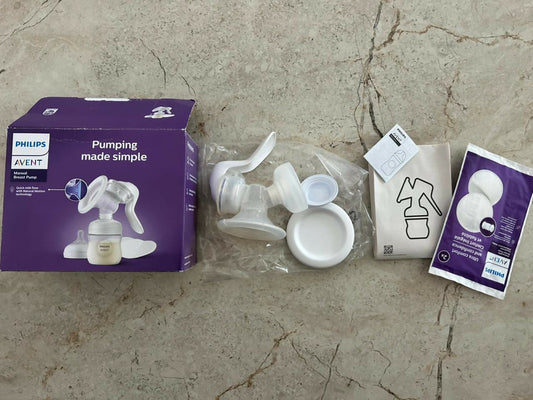 Philips Avent breast pump parts on a concrete floor