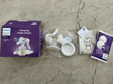 Philips Avent breast pump parts on a concrete floor