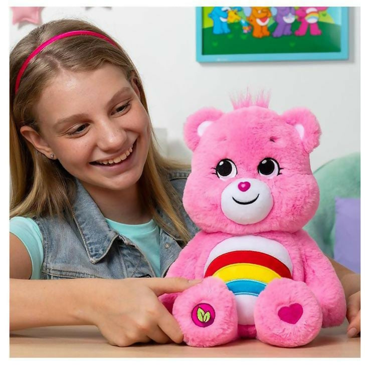 a pink teddy bear with a rainbow design