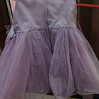 Light purple dress hanging on a rack 