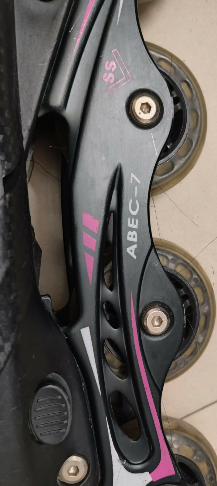 Close-up of a rollerblade with ABEC-7 bearings on a dark background