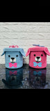 Two small storage baskets shaped like dogs, one blue and one pink