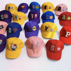 Collection of colorful children's baseball caps with various designs and letters 