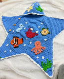 Handmade Crochet Baby Cocoon with Patches featuring a cozy handcrafted design, soft crochet texture, and charming decorative patches, ideal for newborn photoshoots, gifting, and supervised cozy moments.