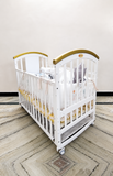HunyHuny Wooden Baby Cot Crib B102 with rocking function, lockable wheels, included mattress, spacious sleeping area, and a sturdy wooden frame for safe and comfortable sleep.