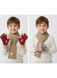 Two images of a boy wearing red gloves with bear designs, a beige scarf, and pink mittens with bear designs 