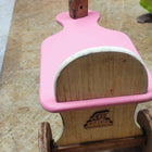 Pink wooden kids balance bike with handlebar and single front wheel, pink, brown