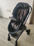 Evenflo travel system with baby stroller and infant car seat, featuring a foldable design, reclining seat, adjustable canopy, 5-point safety harness, and spacious storage basket for convenient travel.