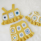 Crocheted outfit with a dress, top, and hat 